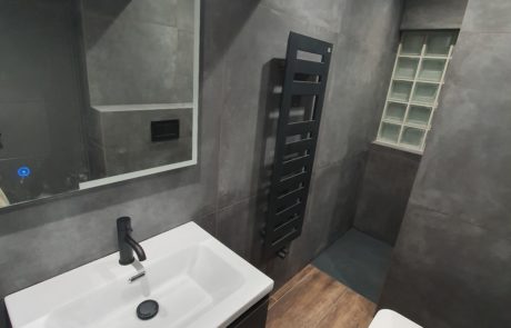 walk in shower and black sanitaryware in refurbished bathroom
