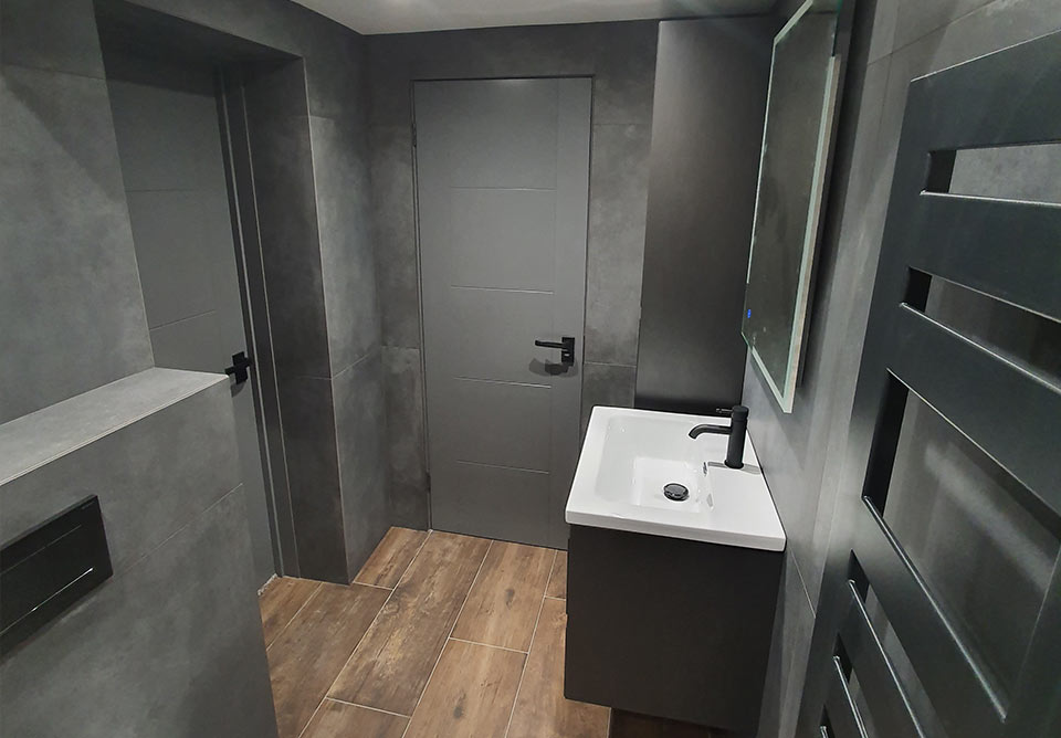 sleek and modern dark grey bathroom by top grade build