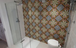 feature wall bold pattern tiles in walk in shower bathroom