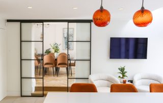 kitchen opening into the dining room with crittall style sliding doors