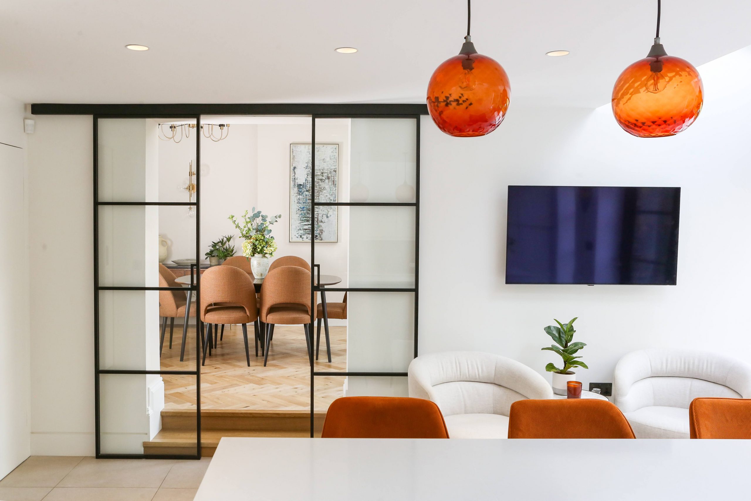 kitchen opening into the dining room with crittall style sliding doors