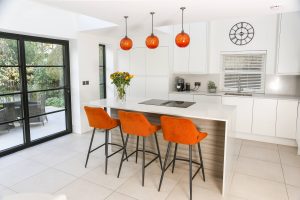 new modern white kitchen with crittall style doors to the garden