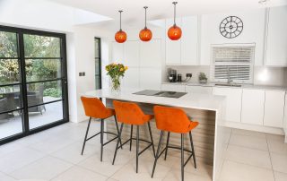 new modern white kitchen with crittall style doors to the garden