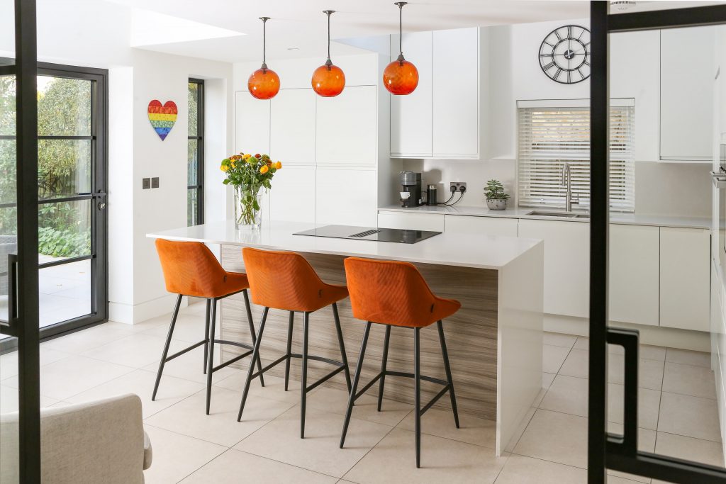 modern kitchen island in twickenham island view with pendant lights in new kitchen of home renovation