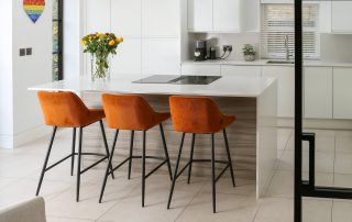 new modern white kitchen with orange accents