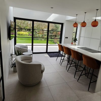 completed new kitchen with build in induction hob in the island and 4 bar stools