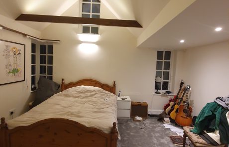 Refurbished bedroom with vaulted ceiling