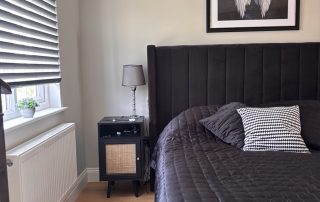 Bed close up with upholstered headboard in black