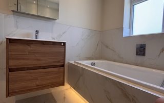 family bathroom details including bath and wooden vanity unity