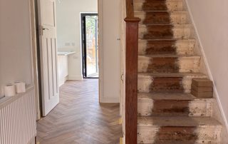 renovated hallway with new wooden flooring in twickenham family home