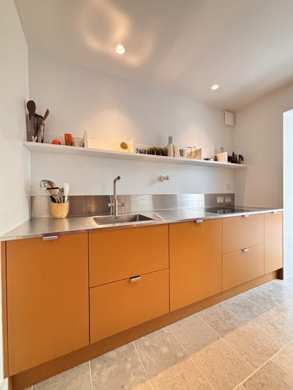 Striking high-design yellow kitchen in west London